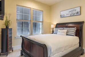 A bedroom with a large bed, a dresser, a window with blinds, and a painting on the wall. - Amalfi Breeze by Avantstay Walk to the Beach, Luxe Design (Miramar Beach)