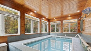 A swimming pool with wooden walls and large windows. - Luxurious Lake George Getaway (Lake George)