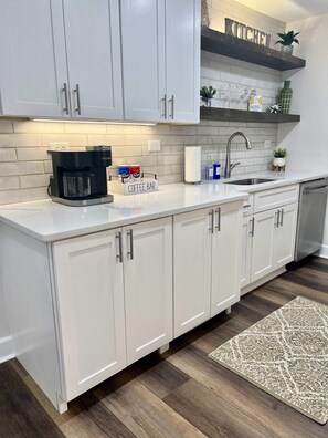 Fridge, microwave, coffee/tea maker, cookware/dishes/utensils