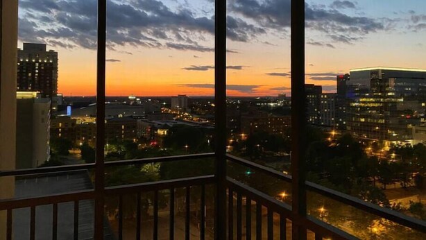 A cityscape at dusk with buildings and a river. - FIFA 2026 Walk to Stadium | 1BR Unit 24B ATL (Atlanta)