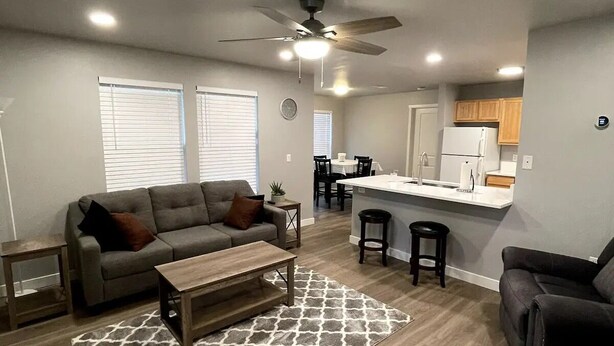 A modern living room with a sofa, coffee table, and patterned rug. - Renovated and Comfortable-South Meridian

 (Meridian)