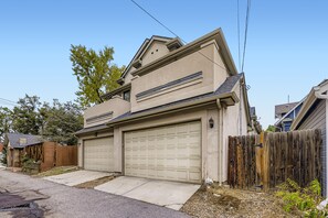 A two-story house with a garage, a wooden fence, and a driveway. - House in front of Washington Park

 (Denver)