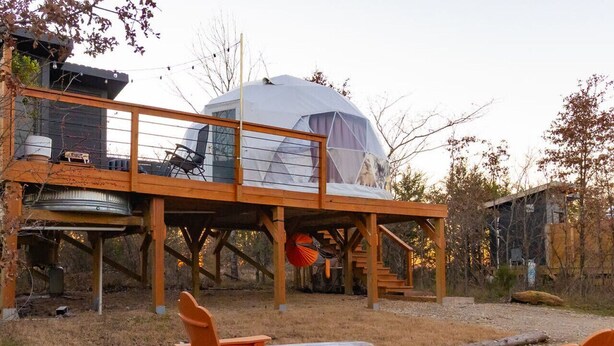 A yurt with a wooden deck and outdoor seating area. - The Elevated Geo Dome at Selah Place (Athens)