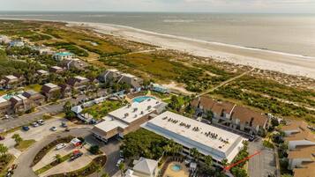 Relax by the pool or on the beach at this coastal hotel, offering a tranquil retreat with a swimming pool and lounge chairs.