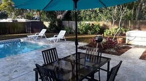 Relax by the pool surrounded by lush greenery and enjoy al fresco dining with family and friends.
