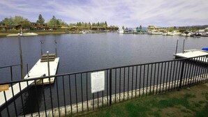 A marina with docked boats, a fenced area, and a signboard. - Waterfront Condo - Easy Lake Access, Private Boat Dock (South Lake Tahoe)