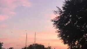 A marina with boats docked, calm water, and a sunset sky. - Waterfront Getaway in Charming Beach Town! (Port Charlotte)