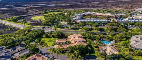 A residential area with houses, a swimming pool, and a large building complex.