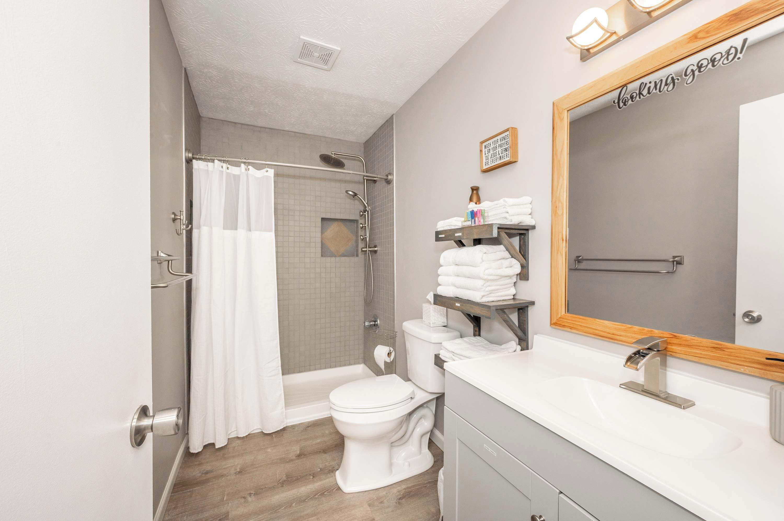 A modern bathroom with a shower, toilet, and vanity.