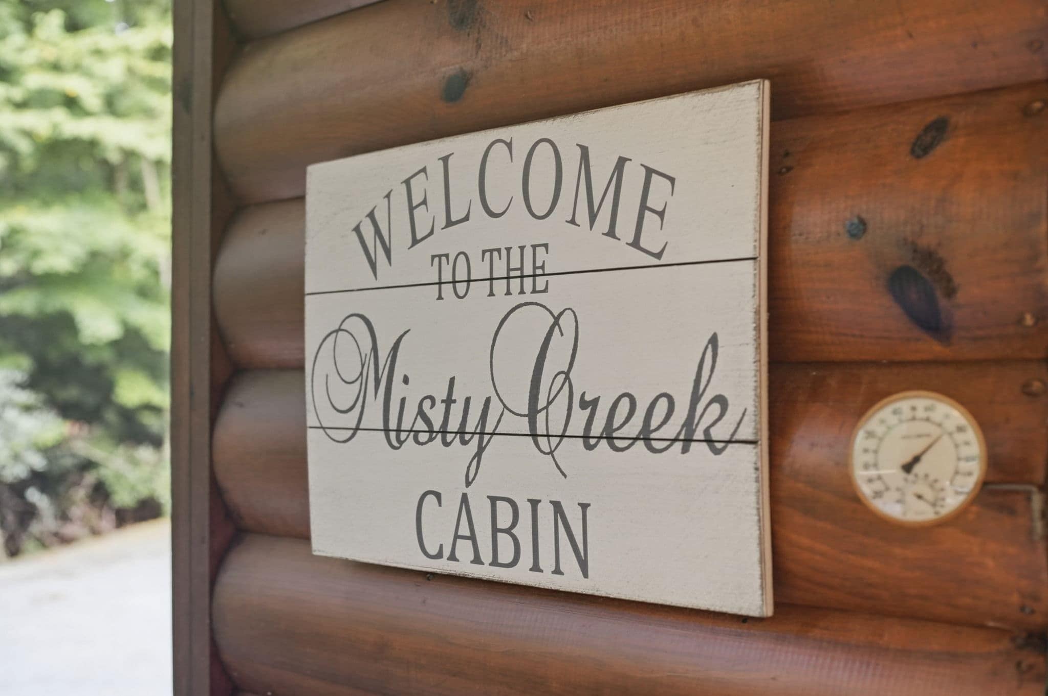 A welcome sign for the Misty Creek Cabin.