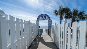 A pathway leading to a beach entrance with a sign reading "Panama City Beach Public Beach Access." - The Turtle Nest Resort Condo w/ Pool! (Panama City Beach)