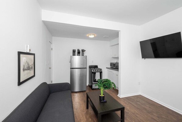 Apartment, 1 Queen Bed, Patio, Garden View | Living area | 42-inch flat-screen TV with digital channels