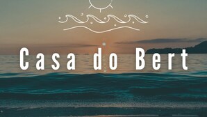 A beach scene with the text "Casa do Bert" and a sun symbol above the waves. - Casa do Bert Itanhaén (Itanhaém)