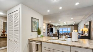 A modern kitchen with a large island, built-in appliances, and a view to the living area. - Spectacular Ocean Front Condo on the Omni Plantation (Fernandina Beach)
