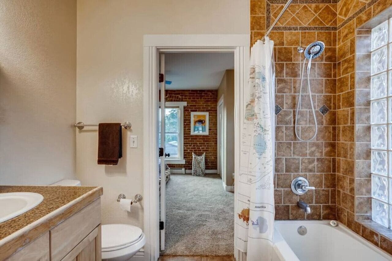 A bathroom with a bathtub, toilet, and sink.