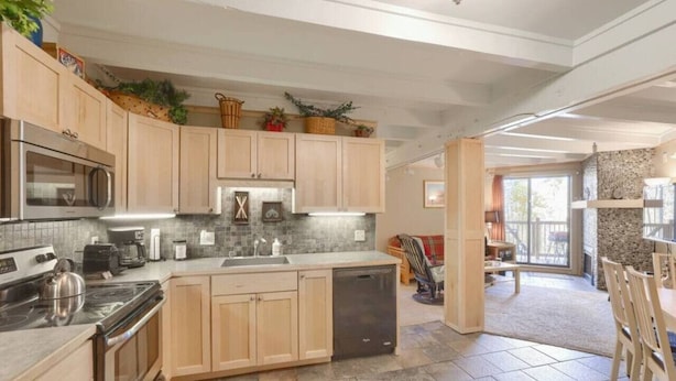 A spacious kitchen with light wood cabinets, a central island, and a stone backsplash. - Fireplace I Pool I Biking I Skiing & Snowboarding (Silverthorne)