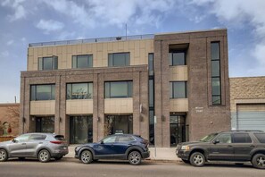 A modern multi-story building with a flat roof and large windows. - Luxury Loft I Skyline Views in RiNO (Denver)