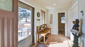 A wooden bench in a hallway with a door leading to a deck area. - Cabin on 13 acres w/ Pool Table & Jacuzzi Tub! (Jefferson)