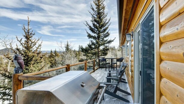 A wooden deck with a grill, outdoor seating, and a view of trees and mountains. - Cabin on 13 acres w/ Pool Table & Jacuzzi Tub! (Jefferson)