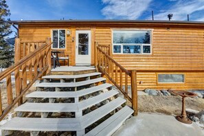 A wooden cabin with a wooden staircase leading to a door marked "WELCOME". - Cabin on 13 acres w/ Pool Table & Jacuzzi Tub! (Jefferson)