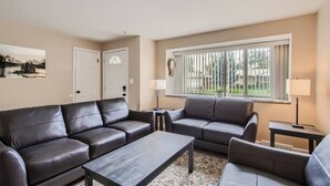 A living room with two sofas, a coffee table, and a window with blinds. - Pet Friendly I 3bd I Red Rocks I Belmar I Denver (Lakewood)