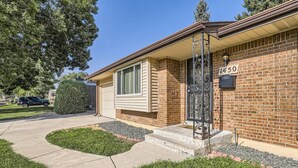 A single-story brick house with a front porch, a garage, and a mailbox. - Pet Friendly I 3bd I Red Rocks I Belmar I Denver (Lakewood)