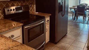 A kitchen with granite countertops, stainless steel appliances, and white cabinetry. - Beautiful home on Lake Hamilton  ! (Lake Hamilton)