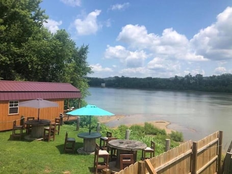 Outdoor dining. Affordable Cozy Cedar Cabin Overlooking the River