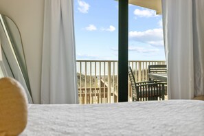 Ein Zimmer mit Blick auf eine Holzterrasse und einen Stuhl.