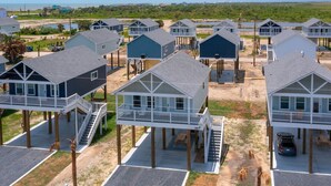 A beachfront property with multiple elevated houses featuring balconies and direct beach access. - Schipps Creek - Ocean & Bay Views (Bolivar Peninsula)