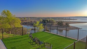 A balcony with a view of a river and trees. -  Nocona Lakefront with 40 private acres, beds for 8, newly constructed in 2024! (Nocona)