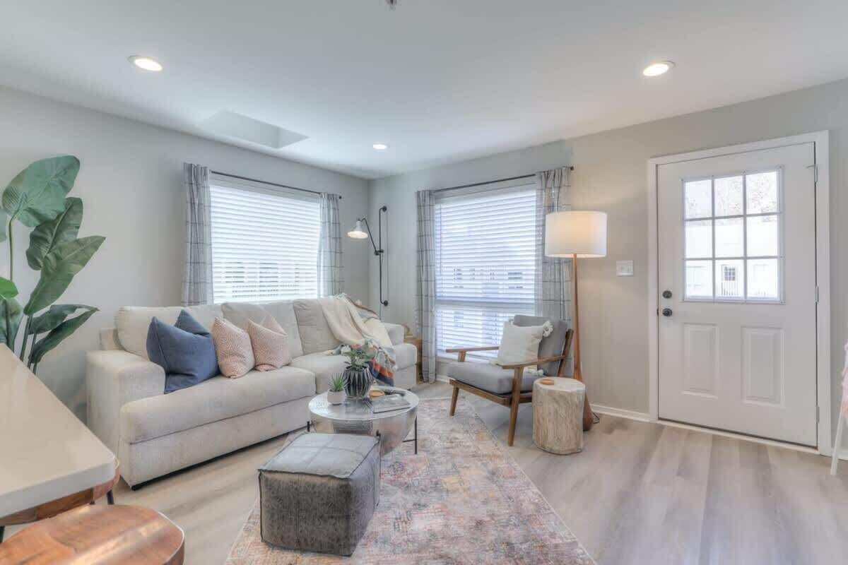 A modern living room with a sofa, coffee table, and a lamp.
