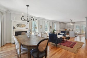 A spacious kitchen with a dining area, featuring a wooden table, chairs, and a chandelier. - 6BR Classic Boston Home | Near Savin Hill T (Boston)