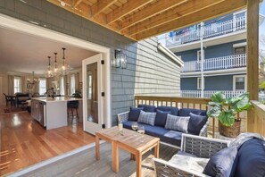 A spacious living area with a wooden ceiling, a dining area, and a kitchen. - 6BR Classic Boston Home | Near Savin Hill T (Boston)