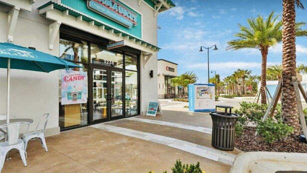 A Bahama Buck's building with a storefront, a directory sign, and outdoor seating. - Your Perfect Family Retreat! (Kissimmee)