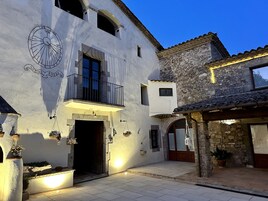 Un edificio tradicional con balcón, una puerta y un reloj en la pared.