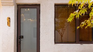 Una puerta con un panel de vidrio y una pequeña señal encima.