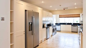A modern kitchen with stainless steel appliances, a built-in oven, and a dishwasher.