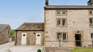 A stone building with two white doors and a small porch area. - Large luxury farmhouse retreat situated in a rural hamlet, perfect for large gatherings of up to 50 (Matlock)