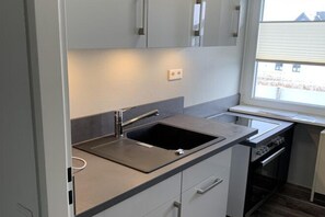 Fridge, microwave, stovetop, coffee/tea maker