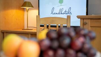 Una silla de madera frente a un escritorio con una lámpara y un letrero que dice "landhotels".
