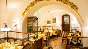A restaurant with an arched ceiling and tables set for dining. - Landhotel Post (Ebensee)