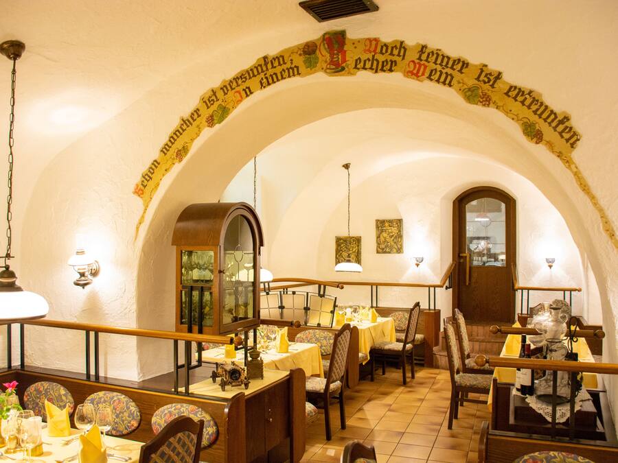 A restaurant with an arched ceiling and tables set for dining.
