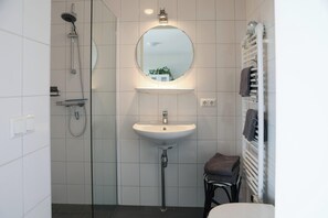 Shower, hair dryer, towels, toilet paper