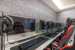 A gaming setup with multiple monitors, a keyboard, and a gaming chair.