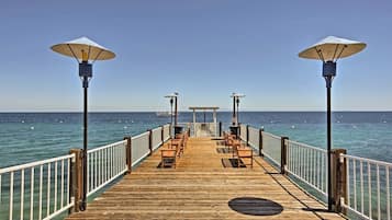 Relax on the pier with scenic views of the calm water and shaded seating areas.