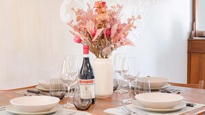 A dining table set with white plates, wine glasses, and a bottle of wine. - ROYAL HOUSE on the Palace of Venaria (Venaria Reale)