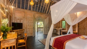 A wooden room with a bed, a desk, and a television. - Wooden Ganeca Villas by GenuineHost (Tegallalang)