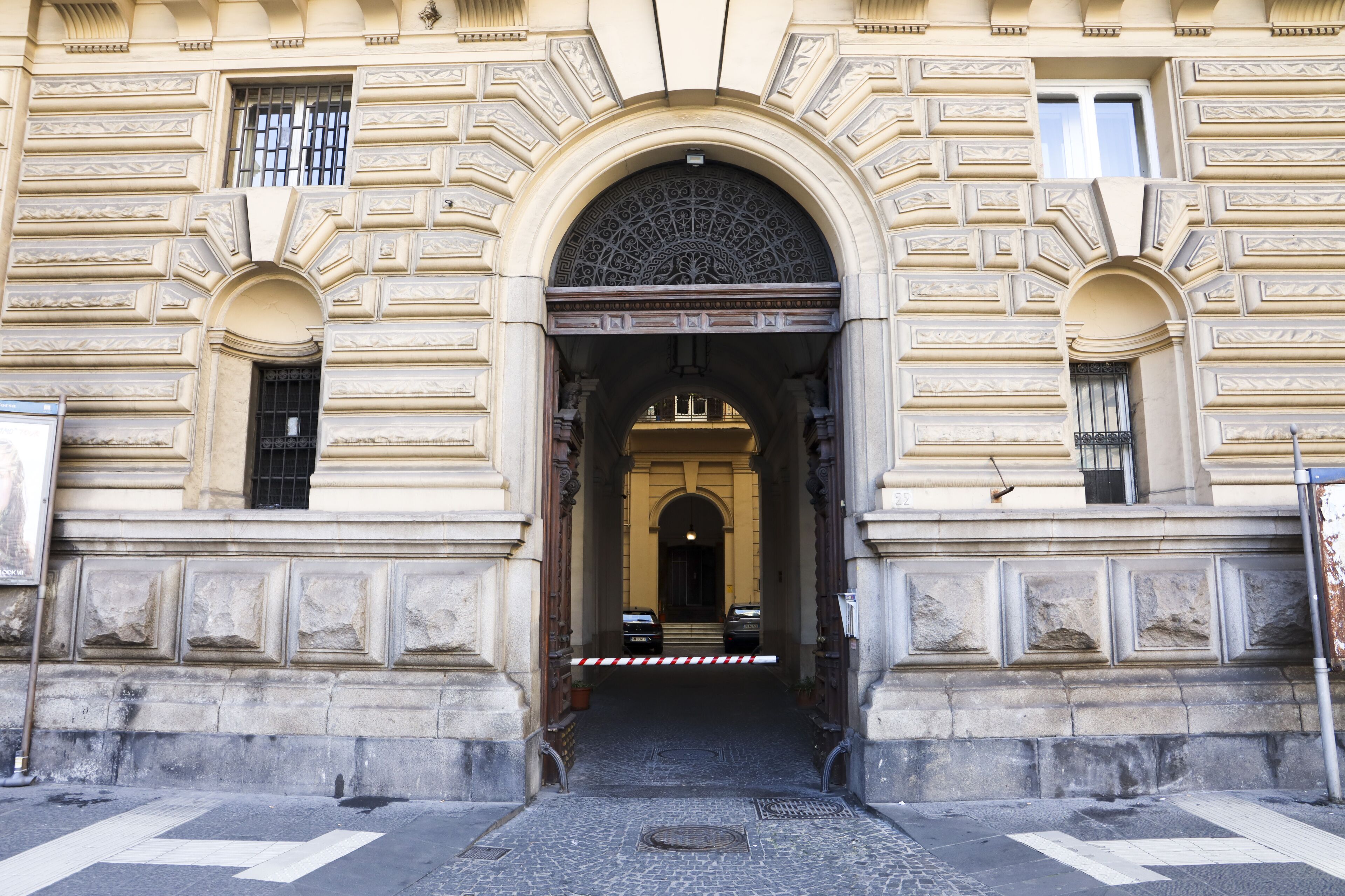 A building entrance with ornate architectural details, including a large arched doorway and decorative moldings.