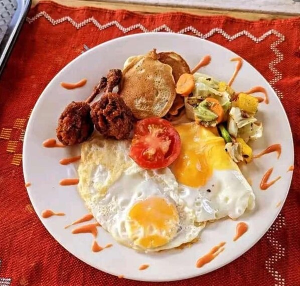 A plate of breakfast food including eggs, toast, and vegetables. - Stadium View Executive Guest House (Lilongwe)